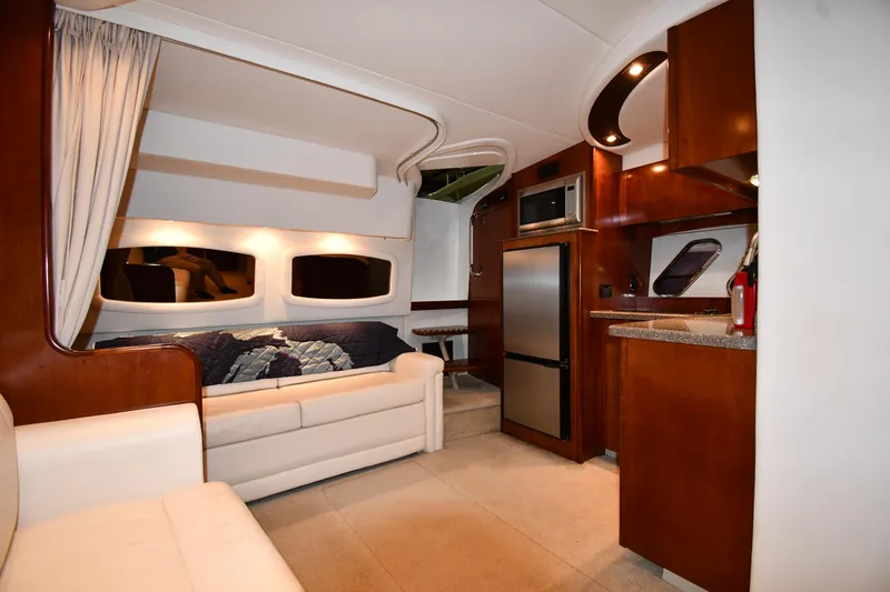 Slide: The Image of Interior of 2012 Cruisers Yachts 390 Sports Coupe, featuring modern kitchen and cozy seating area. - 37