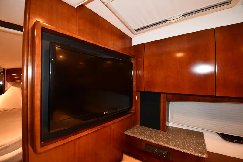 Slide: The Image of Interior of 2012 Cruisers Yachts 390 Sports Coupe with TV and wooden cabinetry. - 45