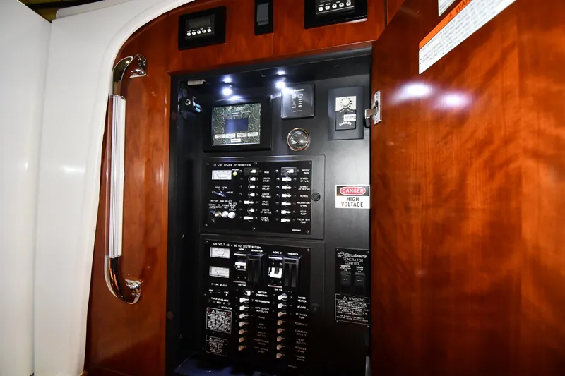 Slide: The Image of Electrical panel inside 2012 Cruisers Yachts 390 Sports Coupe with wood finish. - 47