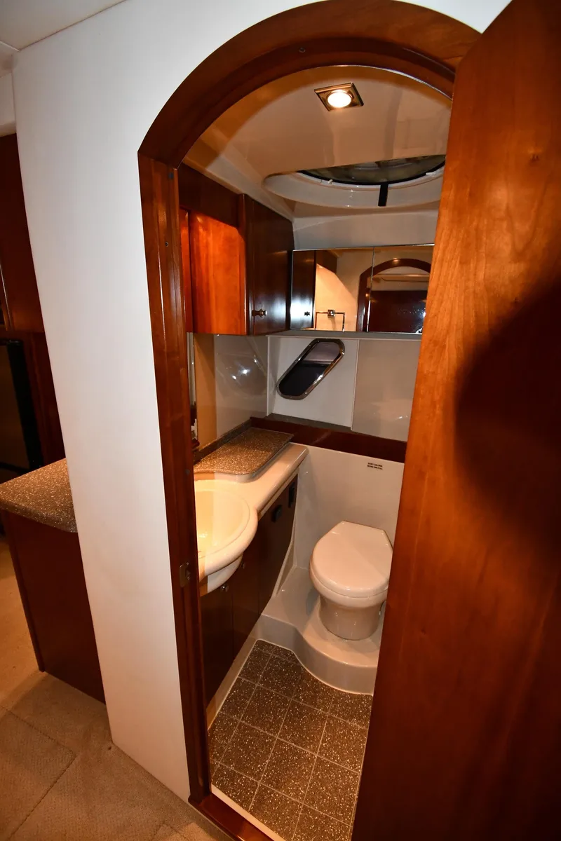 Slide: The Image of 2012 Cruisers Yachts 390 Sports Coupe bathroom with wooden cabinetry and modern fixtures. - 48