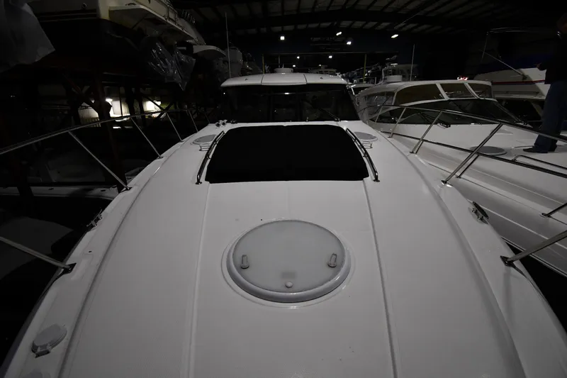 Slide: The Image of 2012 Cruisers Yachts 390 Sports Coupe in a dimly lit marina. - 5