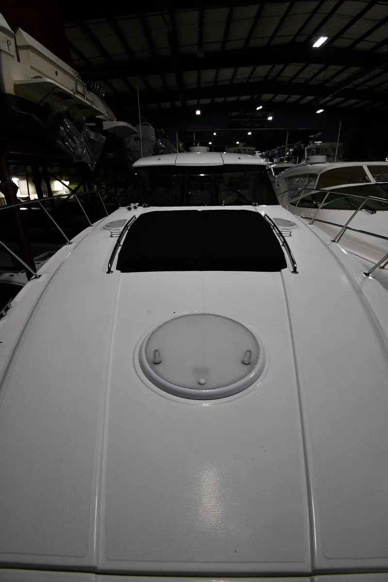 Slide: The Image of 2012 Cruisers Yachts 390 Sports Coupe in a dimly lit indoor storage facility. - 6