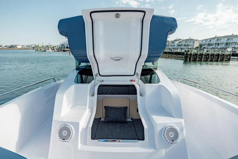 Slide: The Image of Interior view of 2025 Axopar 29XC Cross Cabin Aft Cabin, featuring modern dashboard and seating. - 9