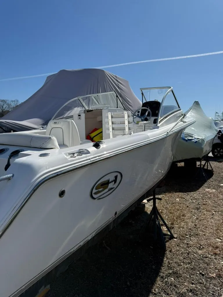 Slide: The Image of 2016 Sea Hunt Escape 211 boat on display under clear blue sky. - 1