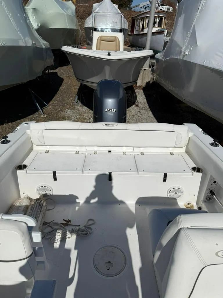 Slide: The Image of 2016 Sea Hunt Escape 211 boat with Yamaha engine, docked among other boats. - 4