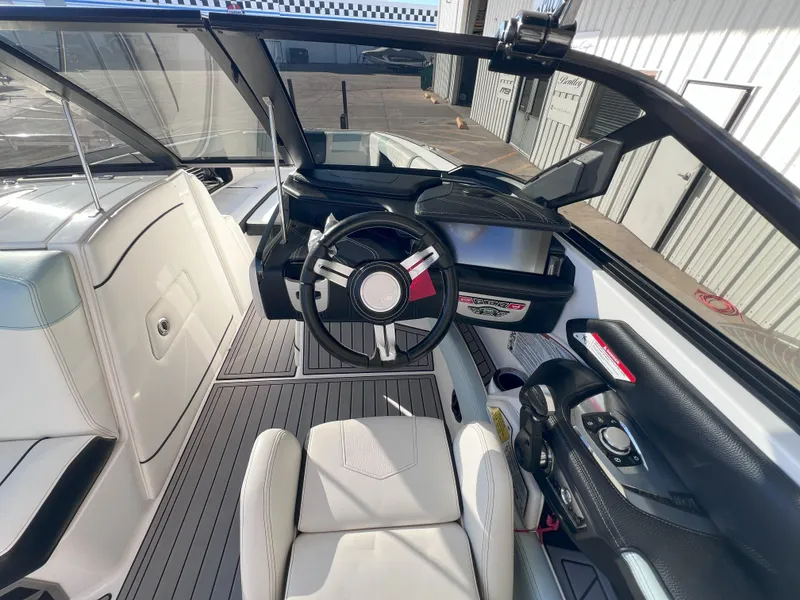 Slide: The Image of 2019 Nautique Super Air Nautique G25 interior with steering wheel and seating. - 13
