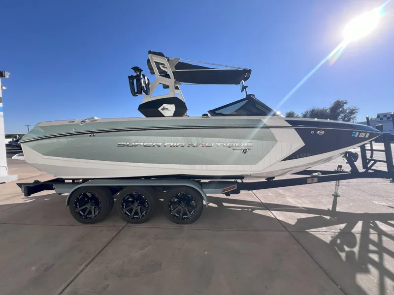 Slide: The Image of 2019 Nautique Super Air Nautique G25 boat on trailer under clear blue sky. - 5