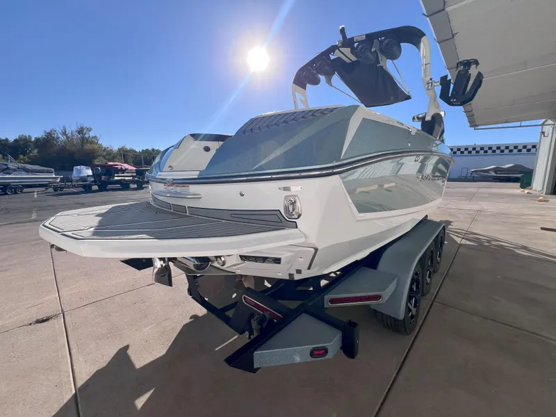 Slide: The Image of 2019 Nautique Super Air Nautique G25 boat on trailer under bright sunlight. - 6