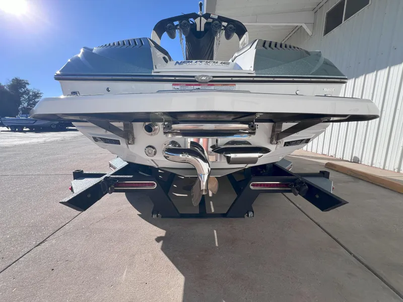 Slide: The Image of 2019 Nautique Super Air Nautique G25 boat rear view on trailer. - 7