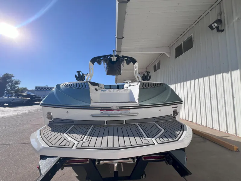Slide: The Image of 2019 Nautique Super Air Nautique G25 boat, rear view, parked outdoors. - 8