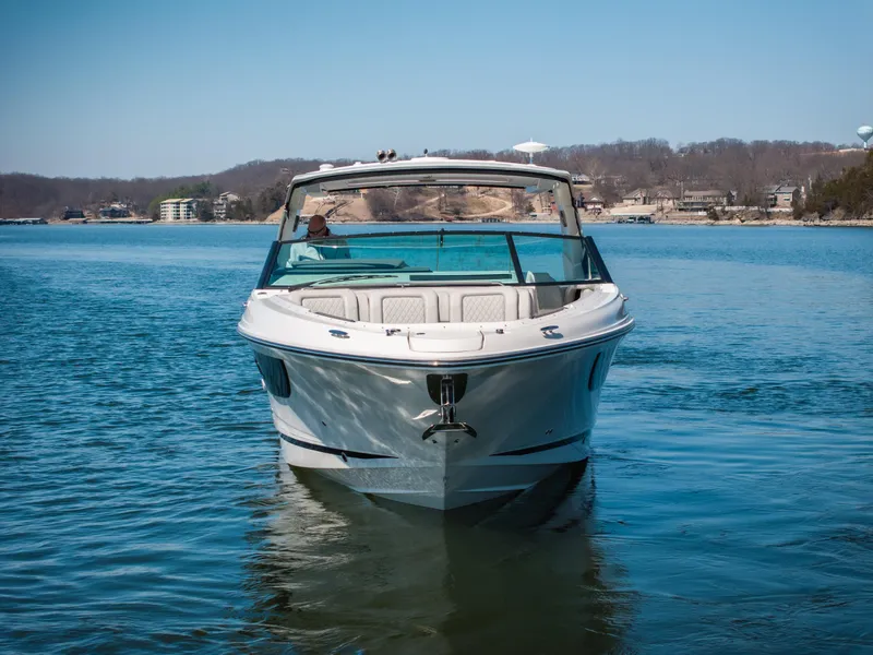 Slide: The Image of 2023 Sea Ray SLX 400 OB boat on a calm lake with scenic background. - 12