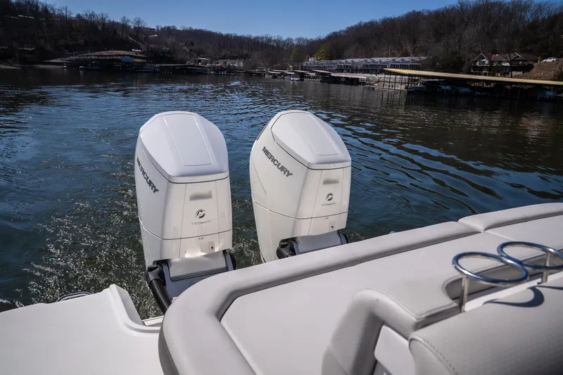 Slide: The Image of 2023 Sea Ray SLX 400 OB with dual Mercury outboard engines on a serene lake. - 13