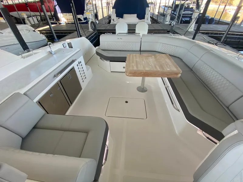 Slide: The Image of 2023 Sea Ray SLX 400 OB boat interior with seating and table. - 19