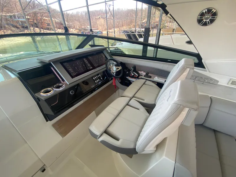 Slide: The Image of 2023 Sea Ray SLX 400 OB helm with modern controls and comfortable seating. - 23