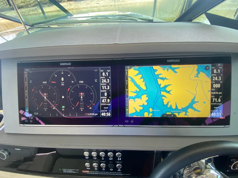 Slide: The Image of Dashboard of 2023 Sea Ray SLX 400 OB with navigation and engine displays. - 28