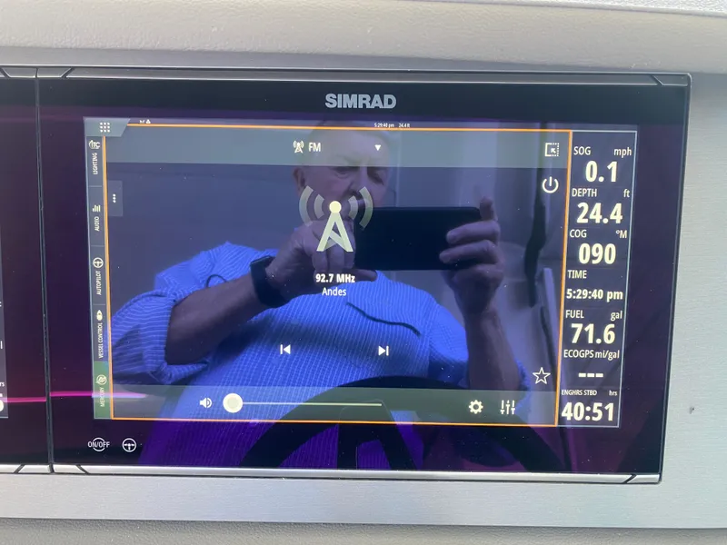 Slide: The Image of Simrad display on 2023 Sea Ray SLX 400 OB showing navigation and radio information. - 29