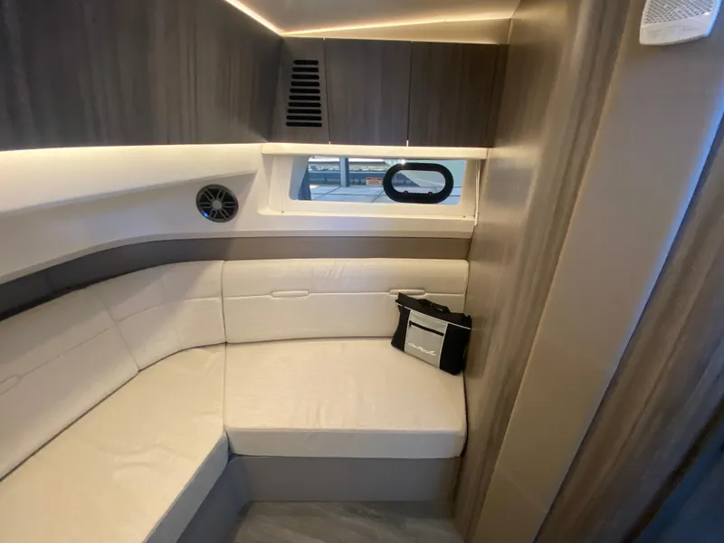 Slide: The Image of 2023 Sea Ray SLX 400 OB cabin interior with modern seating and window view. - 39