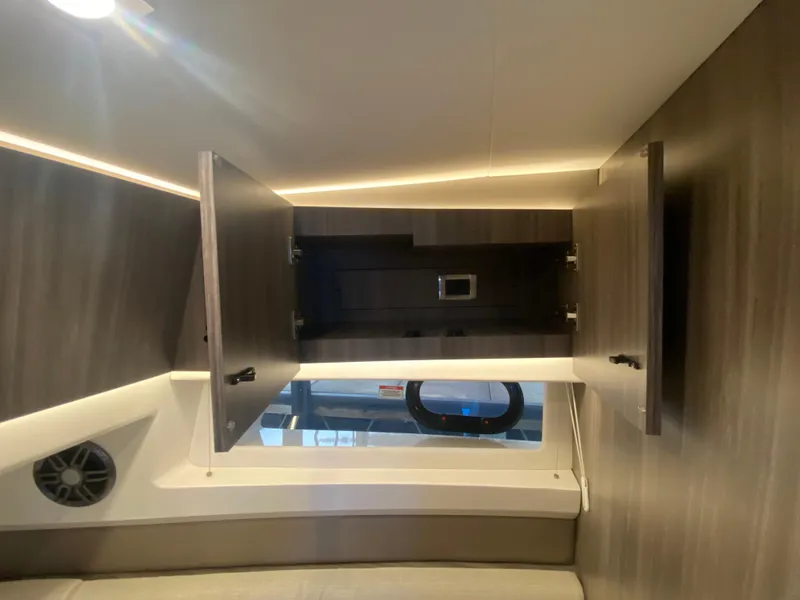 Slide: The Image of 2023 Sea Ray SLX 400 OB interior cabin with open storage compartments. - 40