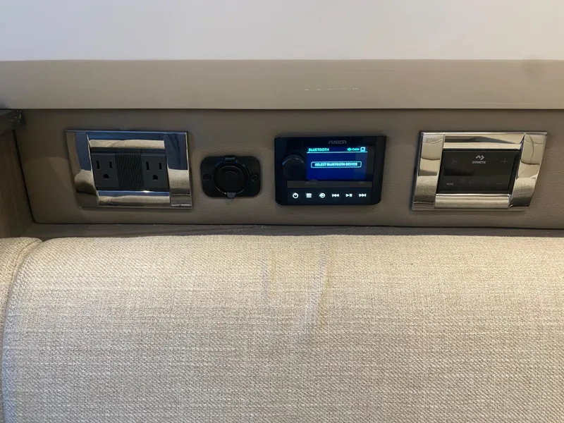 Slide: The Image of Control panel on 2023 Sea Ray SLX 400 OB boat, featuring outlets and digital display. - 41