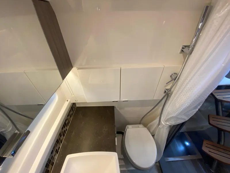 Slide: The Image of 2023 Sea Ray SLX 400 OB bathroom with modern fixtures and shower. - 46