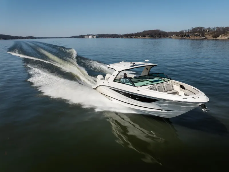 Slide: The Image of 2023 Sea Ray SLX 400 OB cruising on a serene lake. - 5