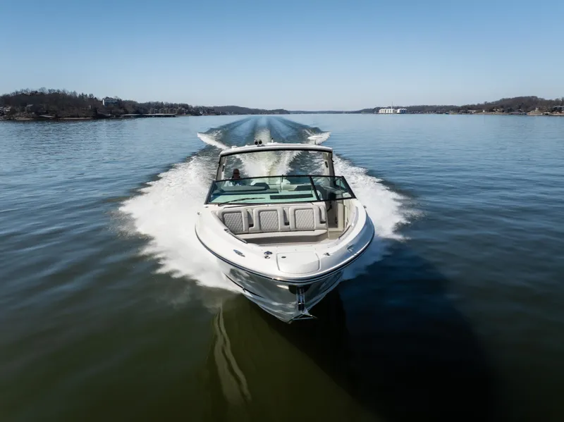 Slide: The Image of 2023 Sea Ray SLX 400 OB cruising on a calm lake. - 7
