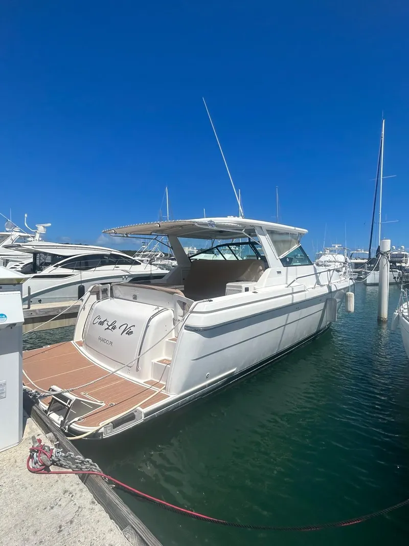 The Image of 2003 Tiara Yachts 4000 Express docked in marina under clear blue sky. - 1