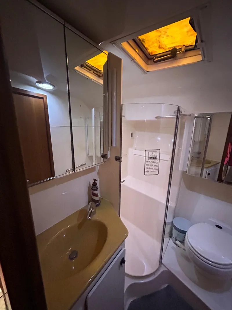 Slide: The Image of Bathroom interior of 2003 Tiara Yachts 4000 Express with shower, sink, and toilet. - 15