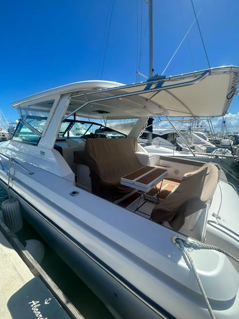 Slide: The Image of 2003 Tiara Yachts 4000 Express docked, featuring spacious seating and sleek design. - 3