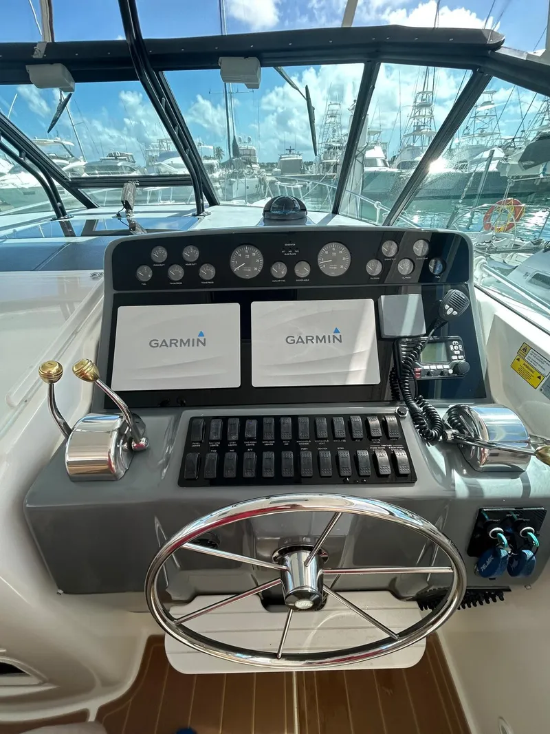 Slide: The Image of Control panel of a 2003 Tiara Yachts 4000 Express with Garmin navigation displays. - 5