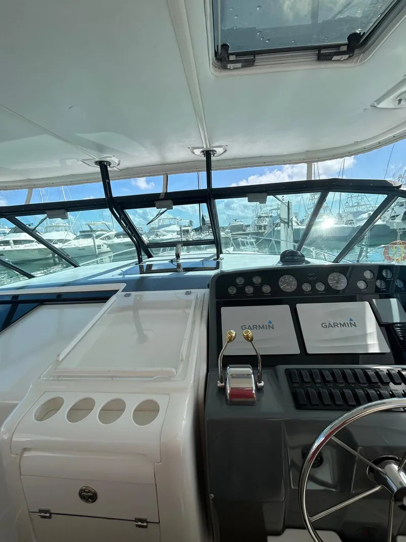 Slide: The Image of 2003 Tiara Yachts 4000 Express helm with Garmin navigation, marina view. - 6
