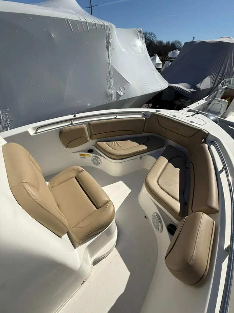 Slide: The Image of 2018 NauticStar 2102 Legacy boat interior with tan seating and white deck. - 7
