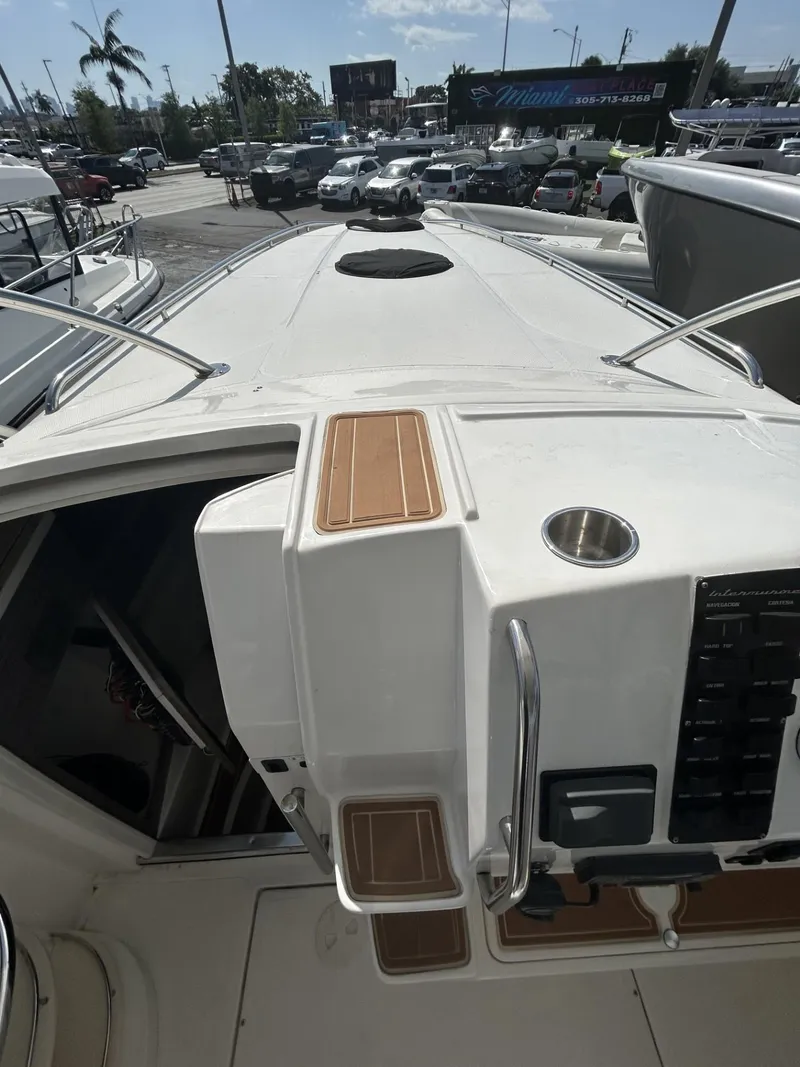 Slide: The Image of 2018 Intermarine 380 Sport yacht deck with control panel and cup holder. - 10