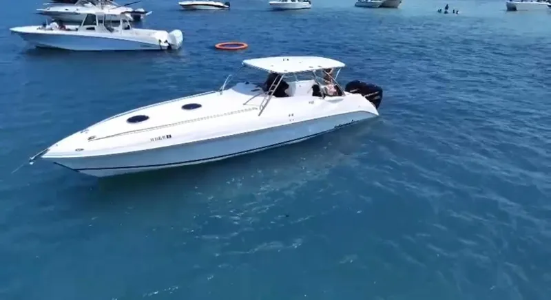 Slide: The Image of 2018 Intermarine 380 Sport boat cruising on clear blue water. - 12