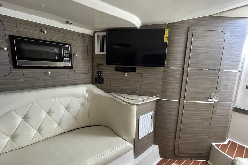Slide: The Image of Interior of 2018 Intermarine 380 Sport yacht with modern amenities, including a microwave and TV. - 32