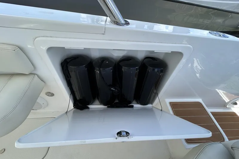 Slide: The Image of Open storage compartment on 2018 Intermarine 380 Sport boat, containing black fenders. - 33
