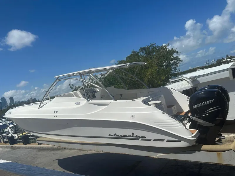 Slide: The Image of 2018 Intermarine 380 Sport boat with Mercury engines, docked under a clear blue sky. - 4
