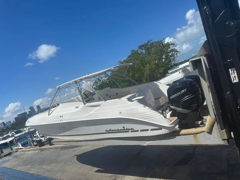 Slide: The Image of 2018 Intermarine 380 Sport boat with Mercury engine on a lift, under clear blue sky. - 5