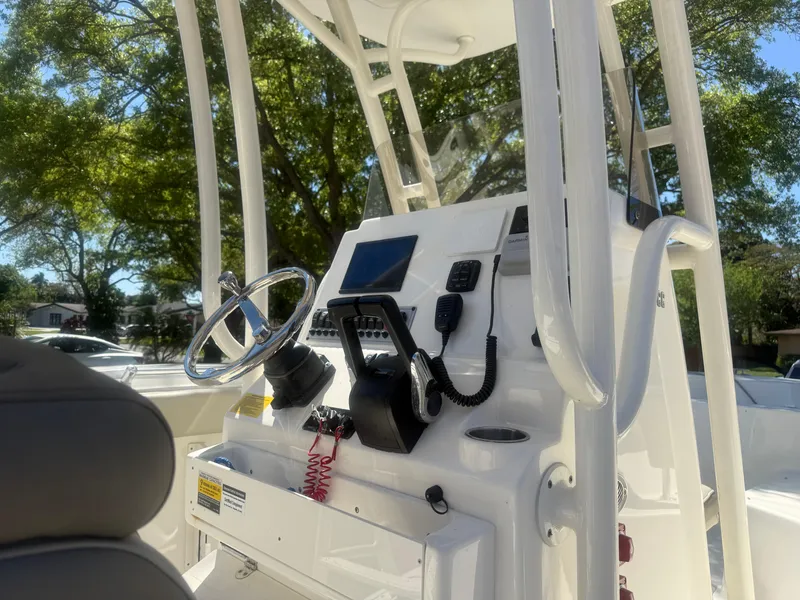 Slide: The Image of 2024 Key West 244CC boat console with steering wheel and navigation equipment. - 4