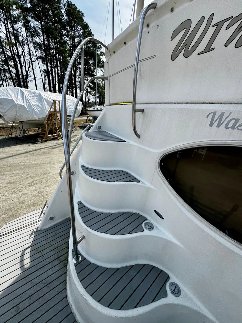 Slide: The Image of Staircase on a 1998 Maxum 4100 SCA yacht, with sleek design and outdoor setting. - 14