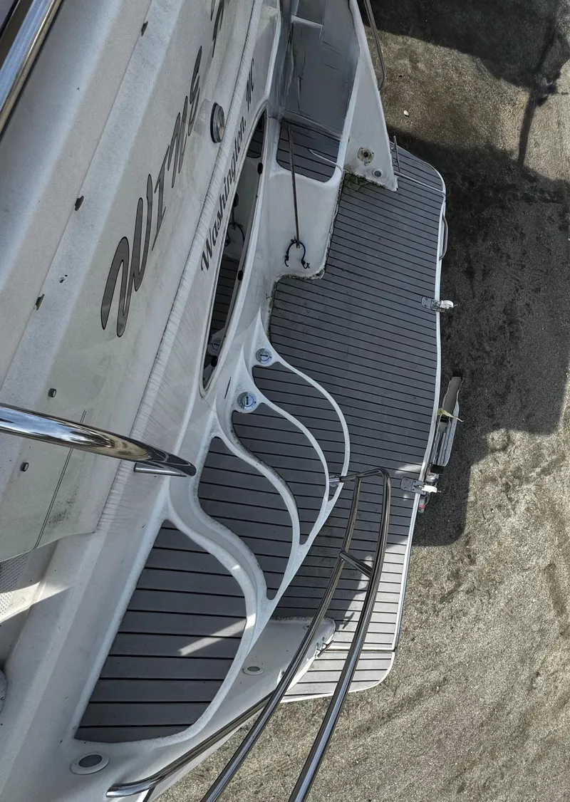 Slide: The Image of 1998 Maxum 4100 SCA yacht, rear deck view with sleek design and railing. - 15