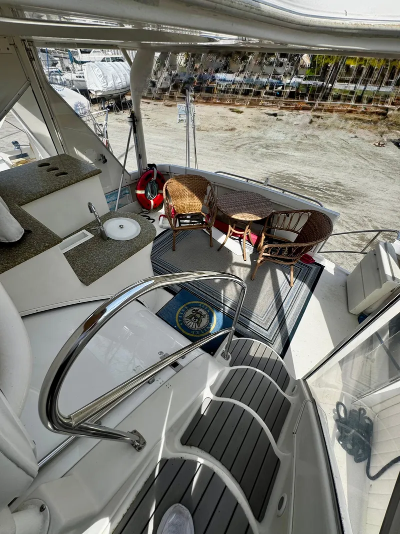 Slide: The Image of 1998 Maxum 4100 SCA yacht interior with seating area and deck view. - 21