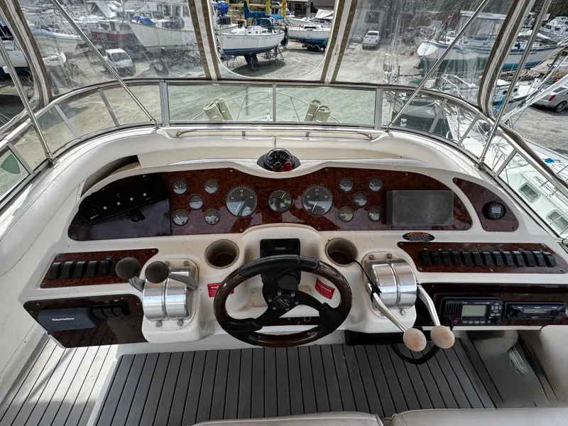 Slide: The Image of Cockpit of 1998 Maxum 4100 SCA yacht with steering wheel and control panel. - 32