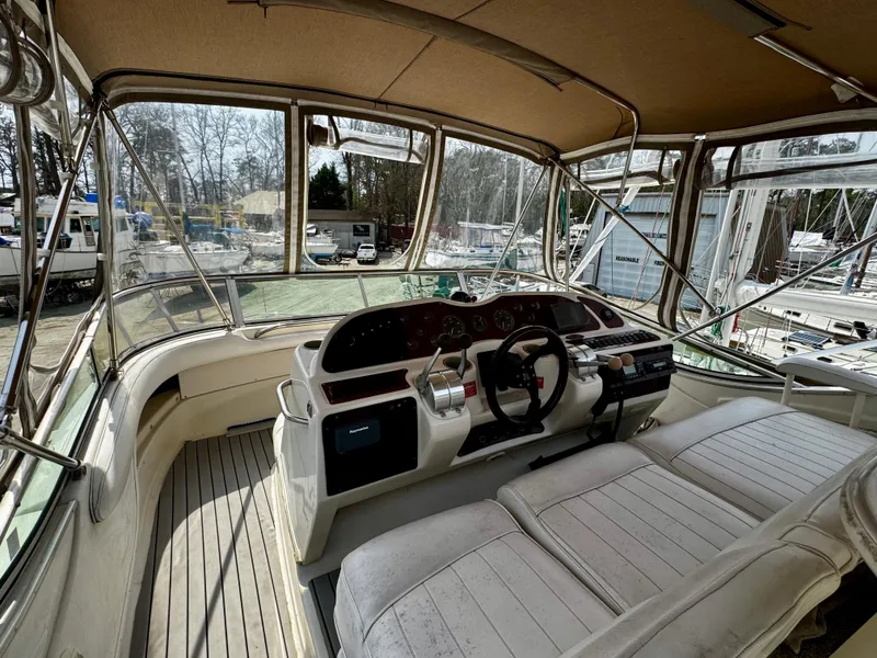 Slide: The Image of 1998 Maxum 4100 SCA boat cockpit with dual seats and steering wheel. - 37