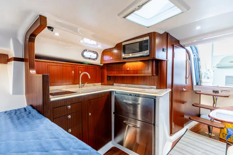 Slide: The Image of Luxurious 2018 Pursuit OS 385 Offshore yacht interior with modern kitchen and wood finish. - 19