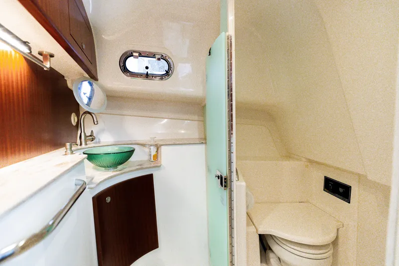 Slide: The Image of 2018 Pursuit OS 385 Offshore boat bathroom with sink, mirror, and toilet. - 26