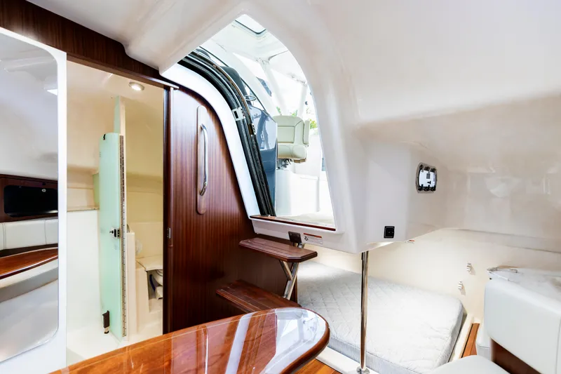 Slide: The Image of Interior of 2018 Pursuit OS 385 Offshore boat, featuring cabin and seating area. - 28