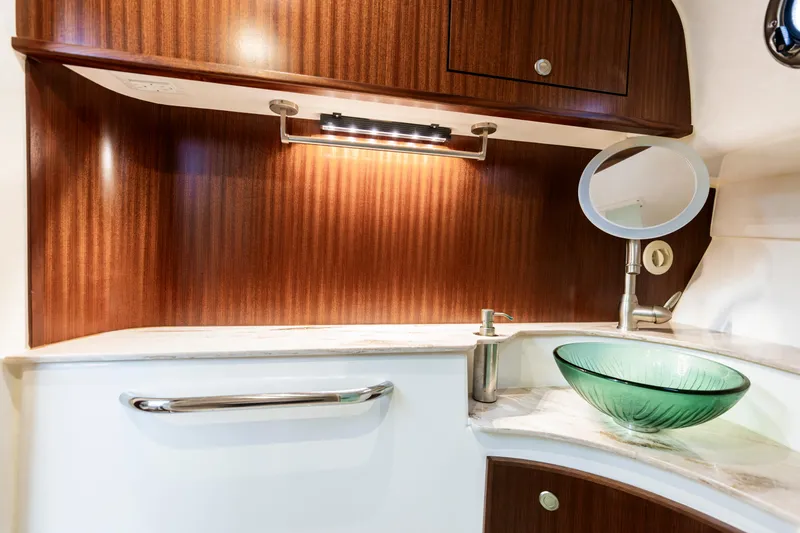 Slide: The Image of Luxurious 2018 Pursuit OS 385 Offshore yacht bathroom with glass sink and elegant wood finish. - 29
