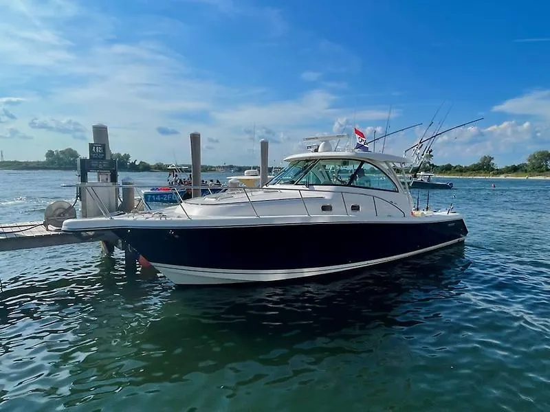 Slide: The Image of 2018 Pursuit OS 385 Offshore boat docked on a sunny day. - 3