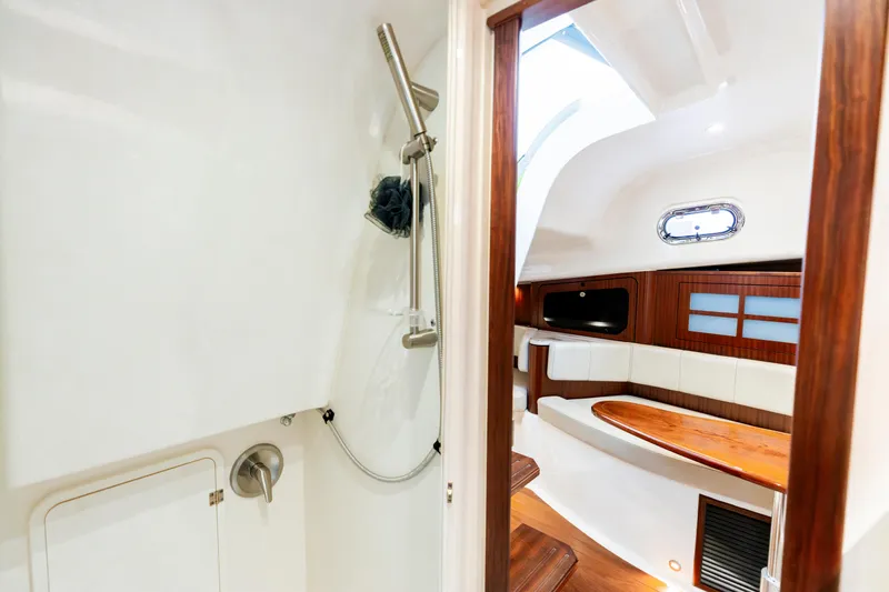 Slide: The Image of 2018 Pursuit OS 385 Offshore interior with shower and seating area. - 30
